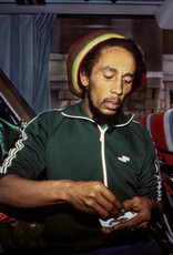 Goldsmith Bob Marley Roll Joint on Bus, 1980 by Lynn Goldsmith