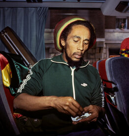 Goldsmith Bob Marley Roll Joint on Bus, 1980 by Lynn Goldsmith