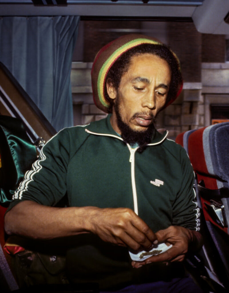 Goldsmith Bob Marley Roll Joint on Bus, 1980 by Lynn Goldsmith