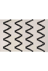 Tapis beige à motifs noirs