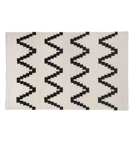 Tapis beige à motifs noirs