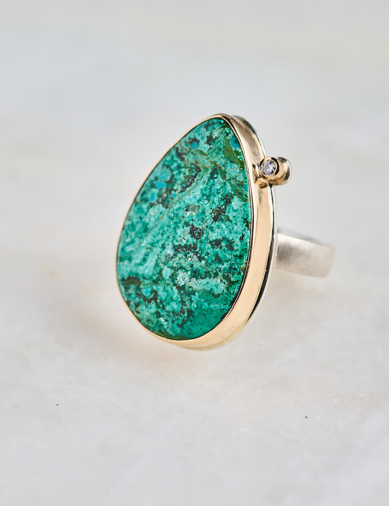 JAMIE JOSEPH Vertical Teardrop Chrysocolla & Satellite Diamond RingHandcrafted in Seattle, this [title of ring from invoice, capitalize stone] with [inset/satellite diamond] is framed in a [lava platform] bezel of 14K [yellow/rose] gold and centered on Jamie's sterlin