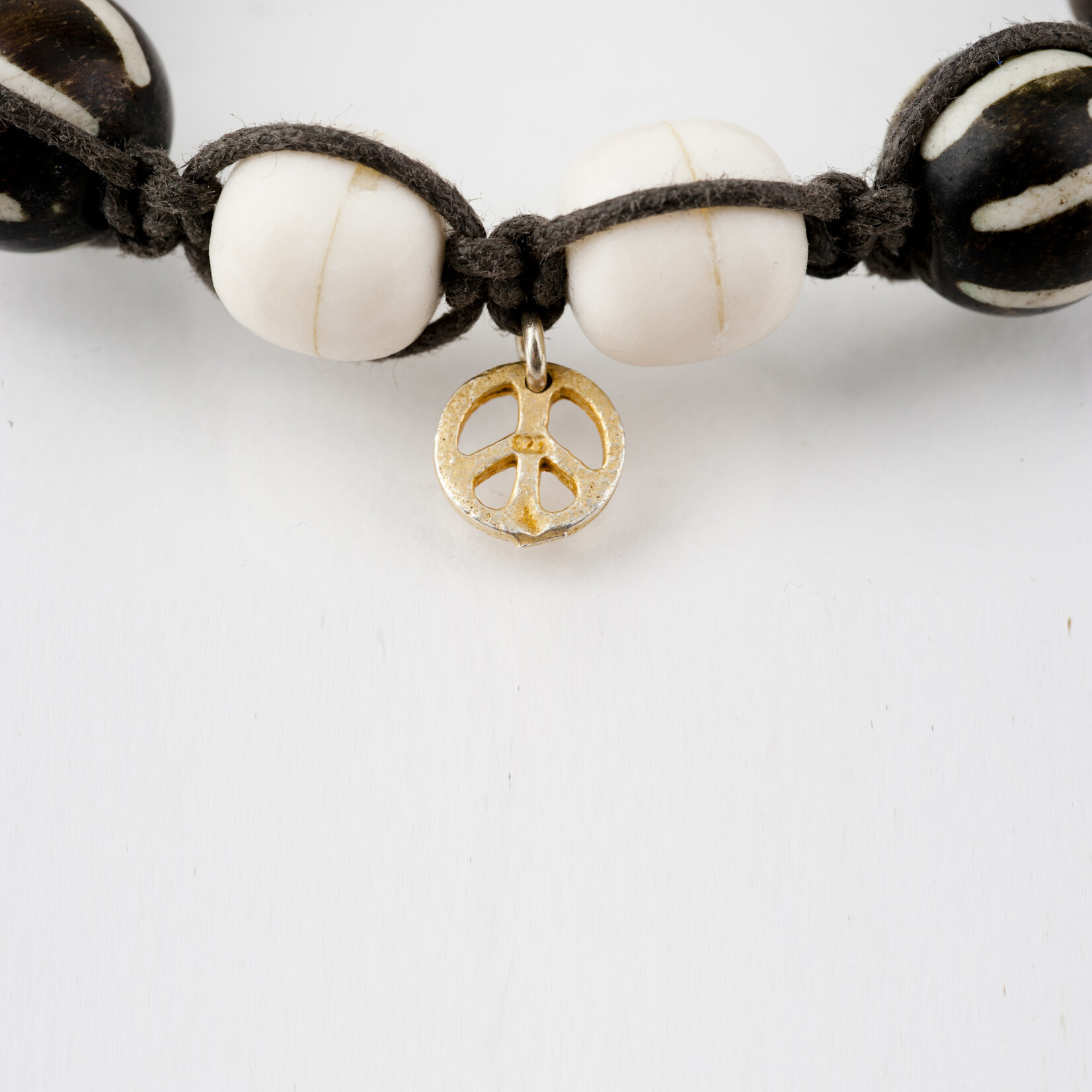 Mina Danielle Macrame Brown and White Bone Beads with Gold Peace Charm