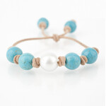 Mina Danielle Turquoise with White South Sea Pearl knotted on Tan Leather Cord. Adjustable sliding closure.