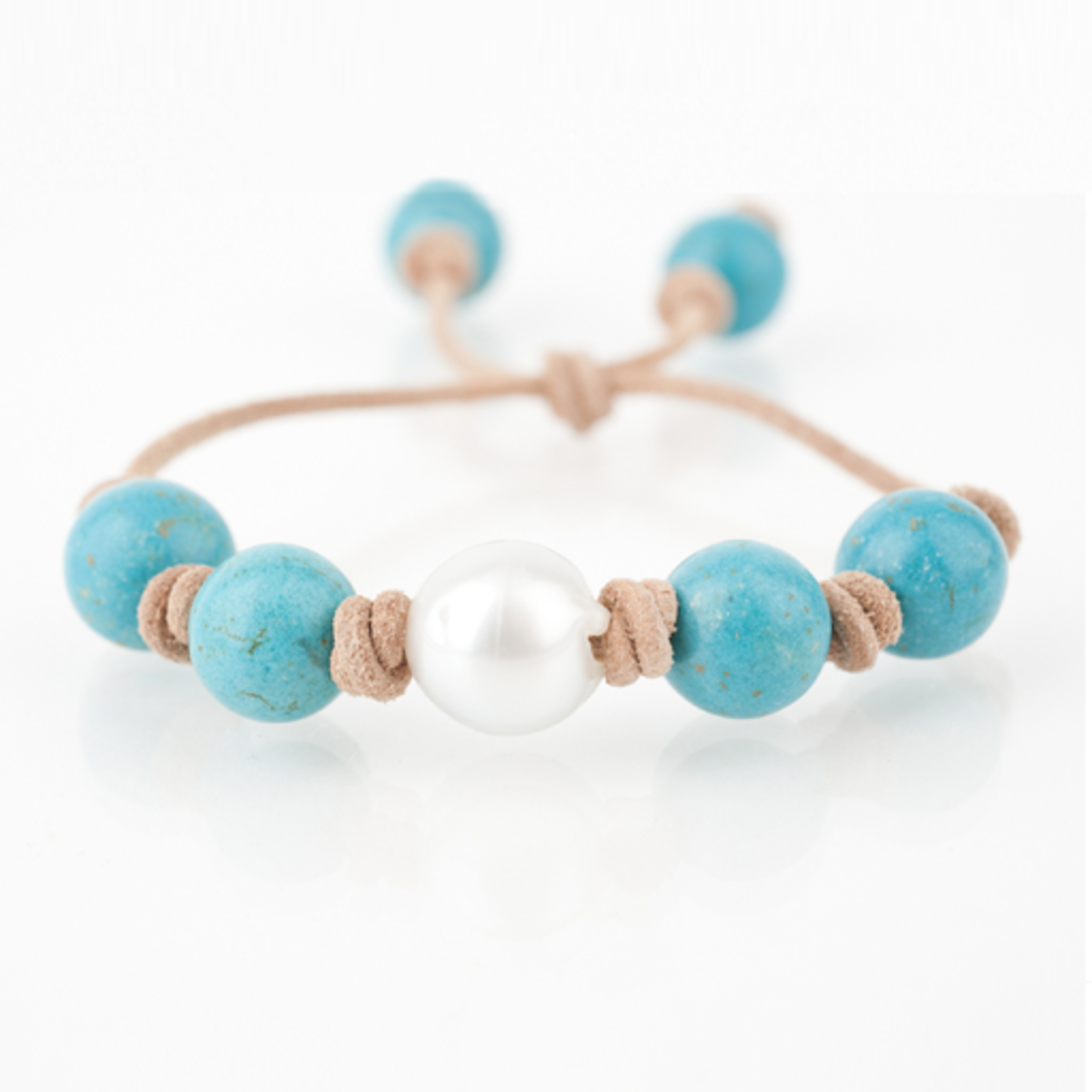 Mina Danielle Turquoise with White South Sea Pearl knotted on Tan Leather Cord. Adjustable sliding closure.