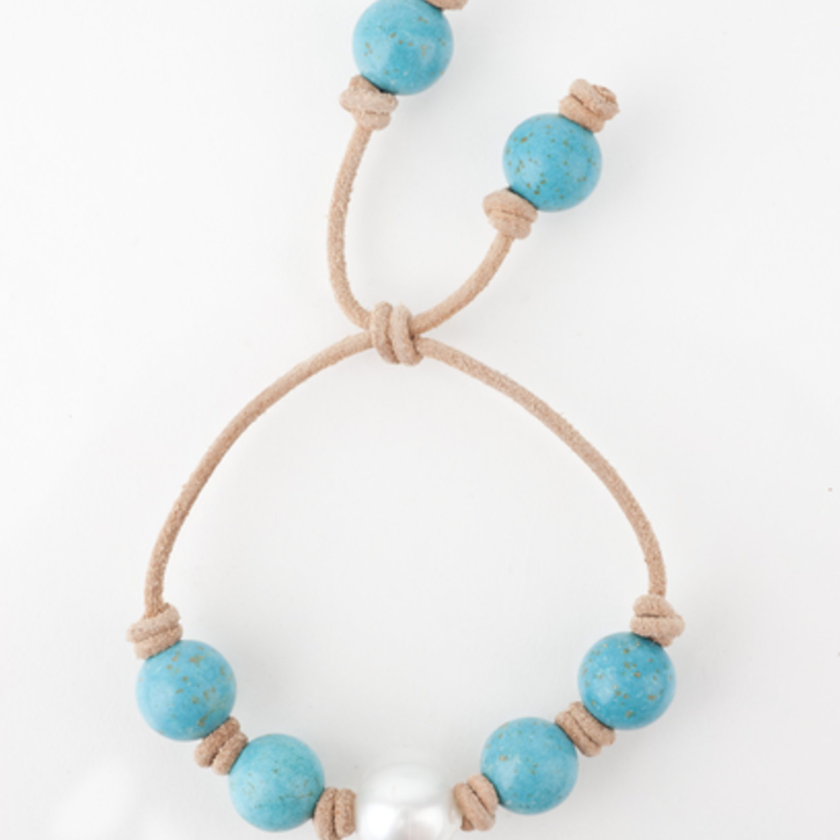 Mina Danielle Turquoise with White South Sea Pearl knotted on Tan Leather Cord. Adjustable sliding closure.