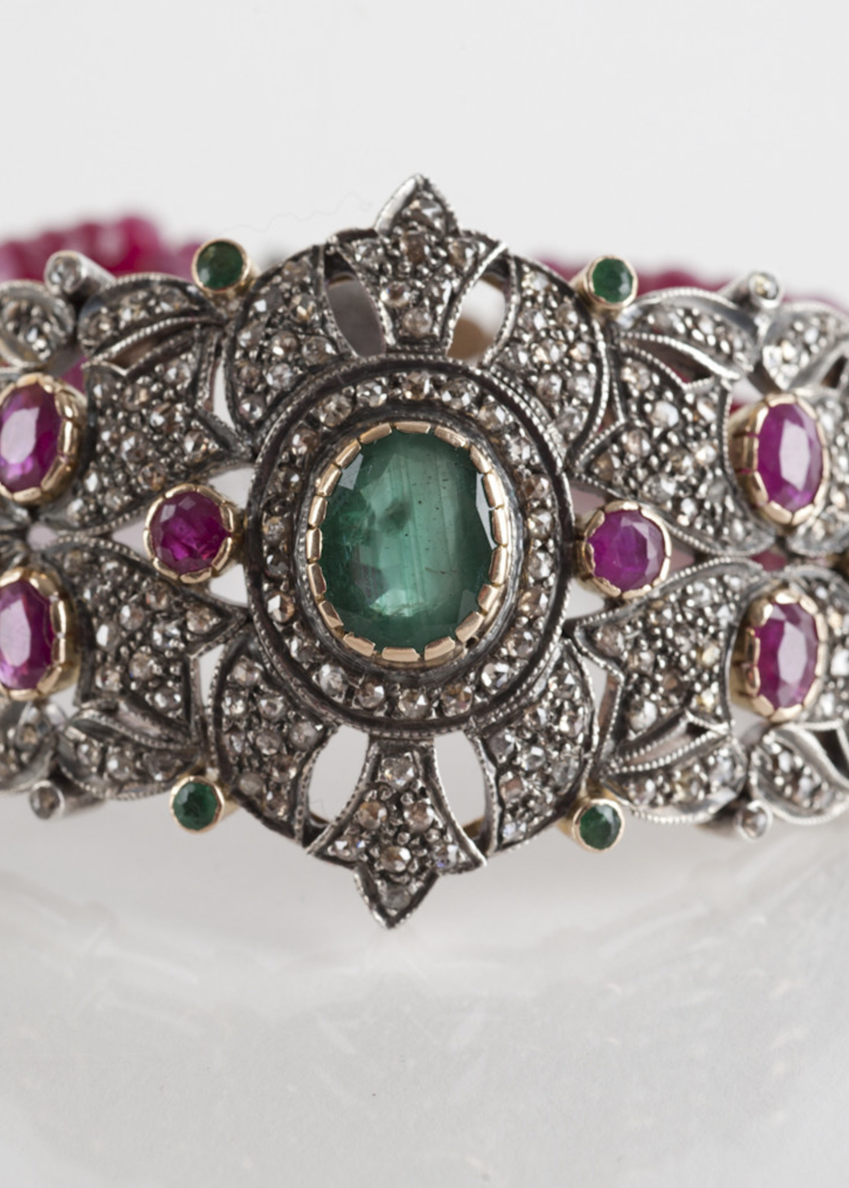 Mina Danielle One of a kind Ruby and Emerald Diamond Brooch Bracelet. Three rows of Ruby Gemstones are strung on each side of the Brooch and finished with a Beautiful Diamond Clasp. This piece can make any outfit.