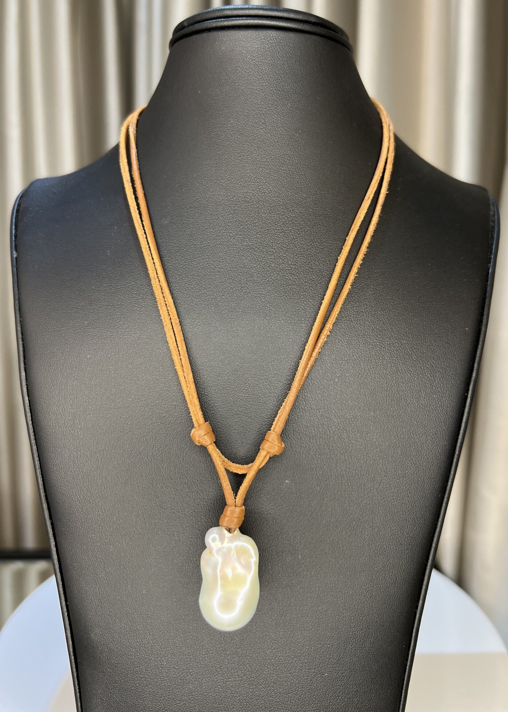 Mina Danielle White Baroque Pearl on double strand light brown leather cord. Pearl button closure.