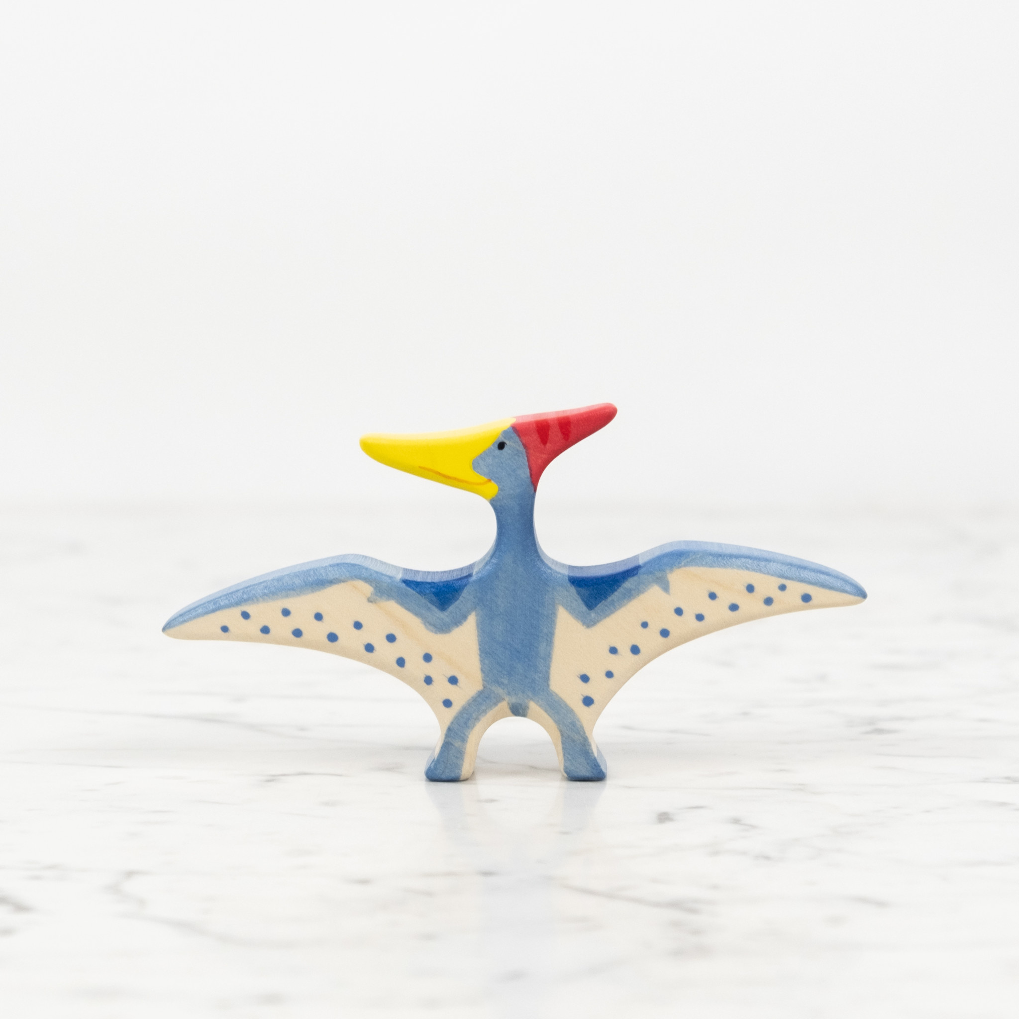Flying Blue Pteranodon Dinosaur with Red Crest and Yellow Beak