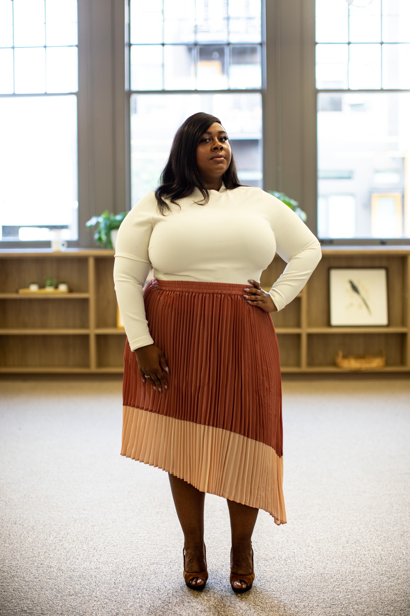 woman wearing a skirt and shirt that highlights her features