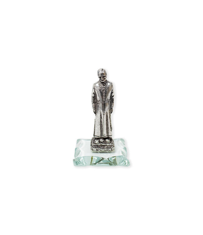 Antique pewter statue of Saint Brother André on glass