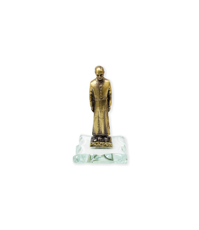 Antique golden statue of Saint Brother André on glass