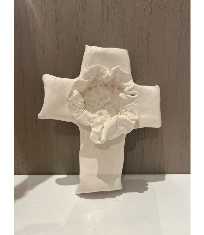 White ceramic cross with center flower. 7x5