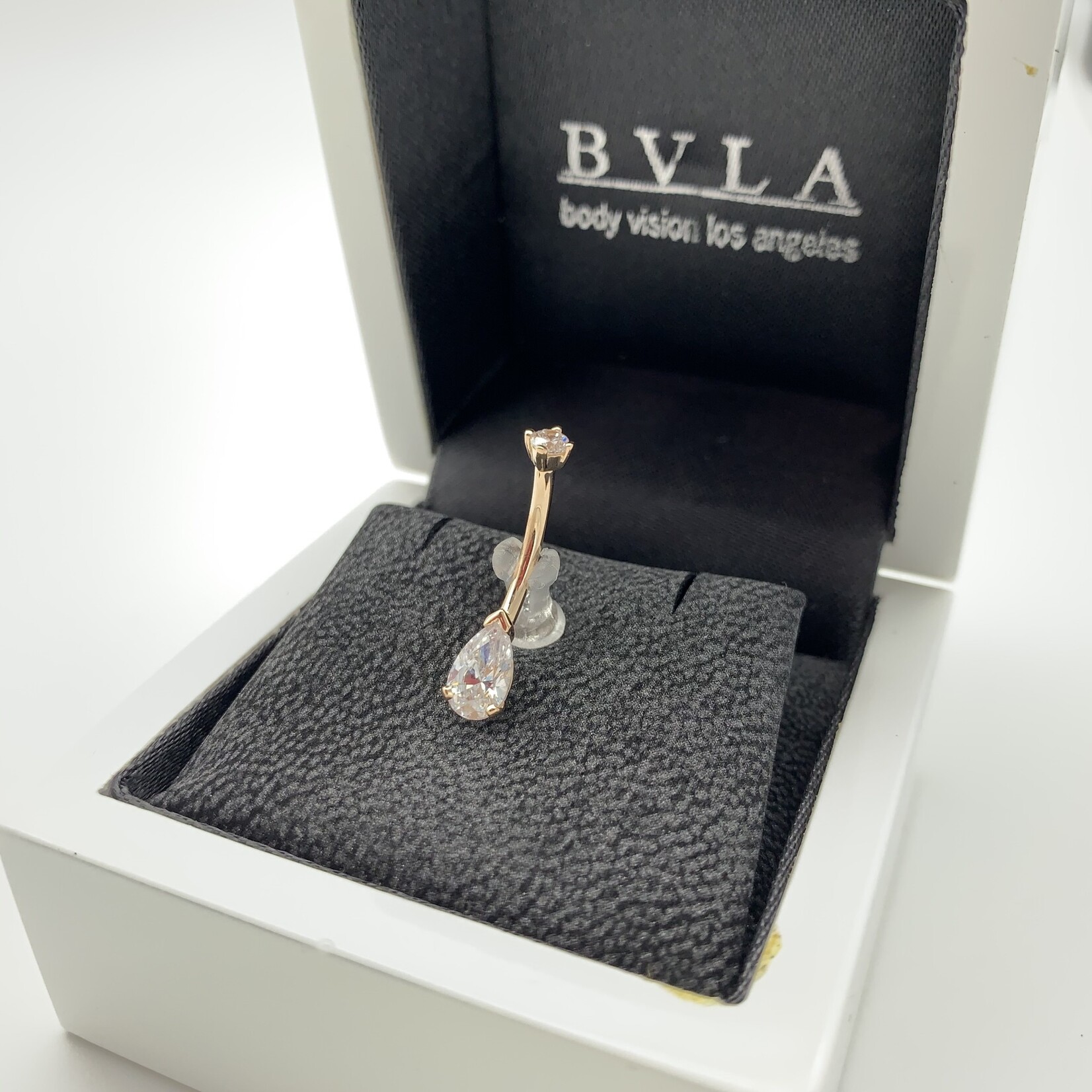 BVLA BVLA 14g 7/16  gold navel curve with prong set, 8x5 pear cut CZ