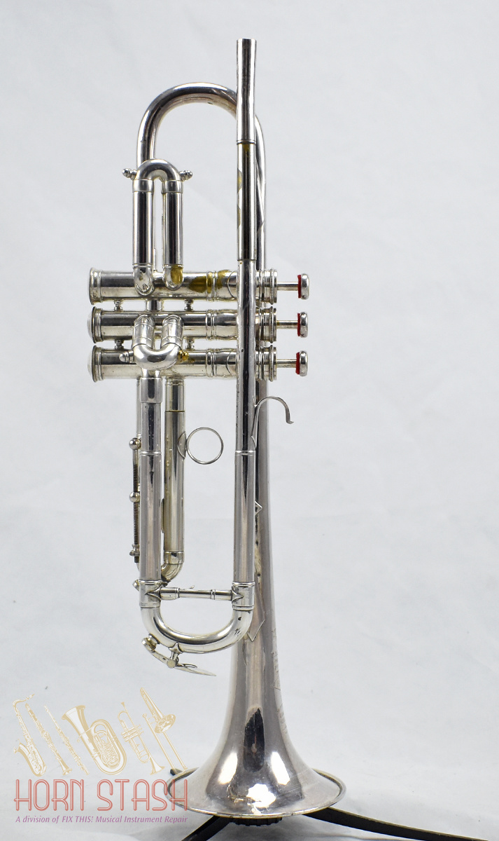 A B&M CHAMPION BRASS TRUMPET With two mouthpieces, in hard carry case.  (case 55cm x 18cm x 12cm)