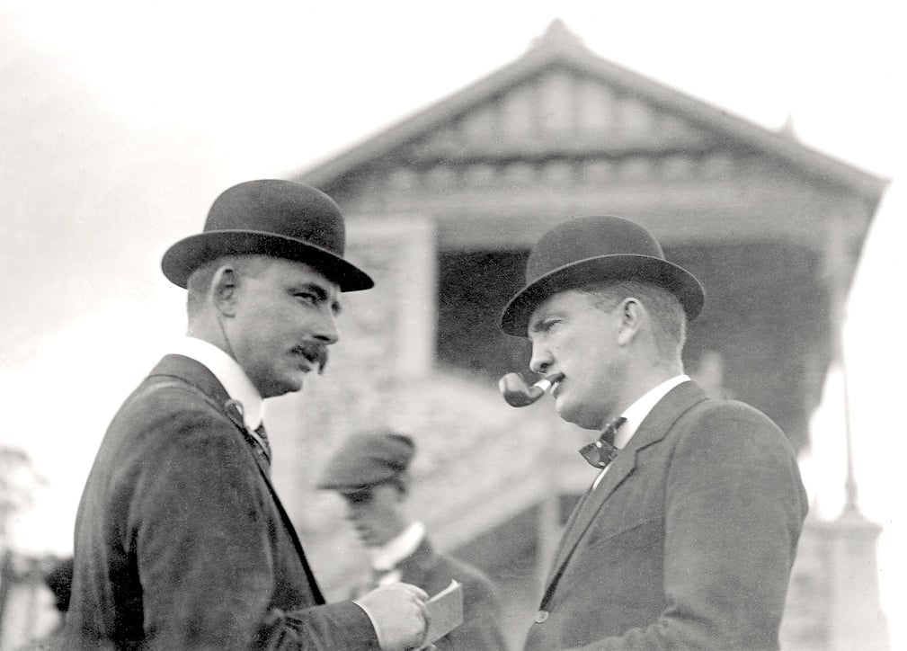 two men at the races in the 1920s wearing bowler hats