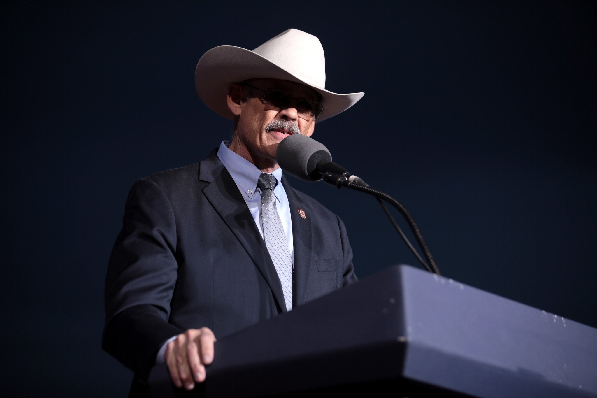 A man in a suit and cowboy hat