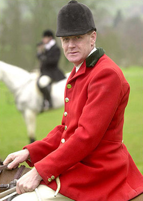 Fox hunter in full hunting pink wearing a hunt cap