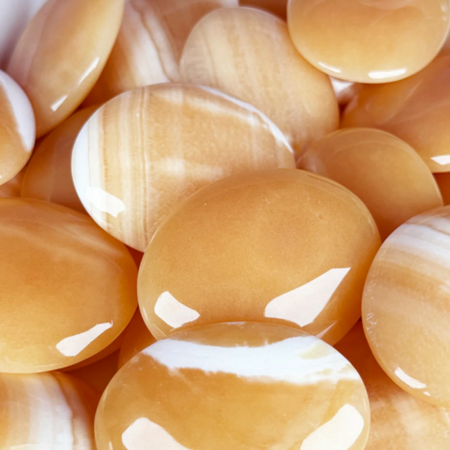 Orange Calcite Palm Pillow Pocket Stone