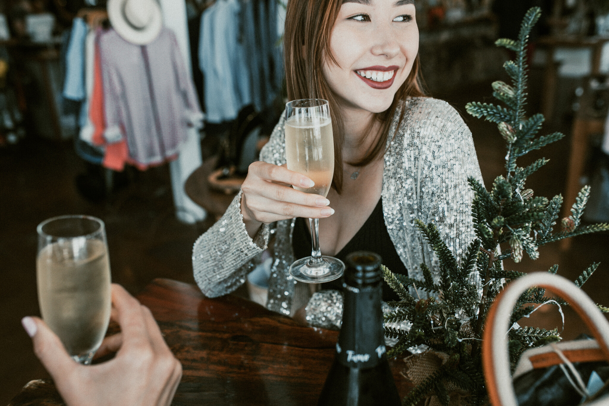 woman smiling raising a glass of champagne