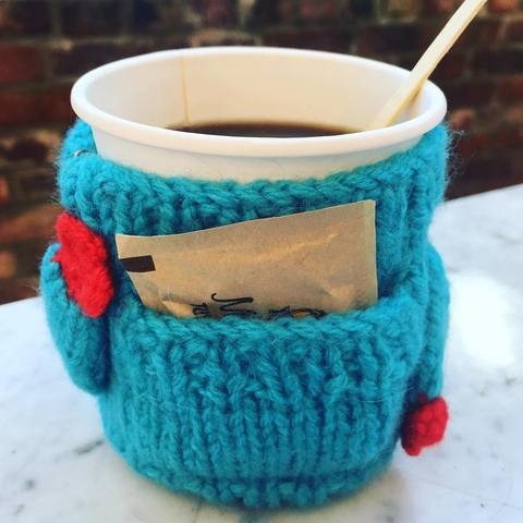 coffee cup in wool cup cozy