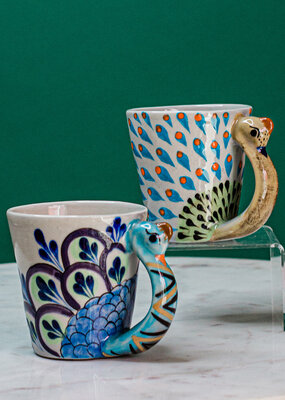 https://cdn.shoplightspeed.com/shops/633301/files/30746909/285x400x1/lucias-imports-hand-painted-ceramic-mug-peacock.jpg