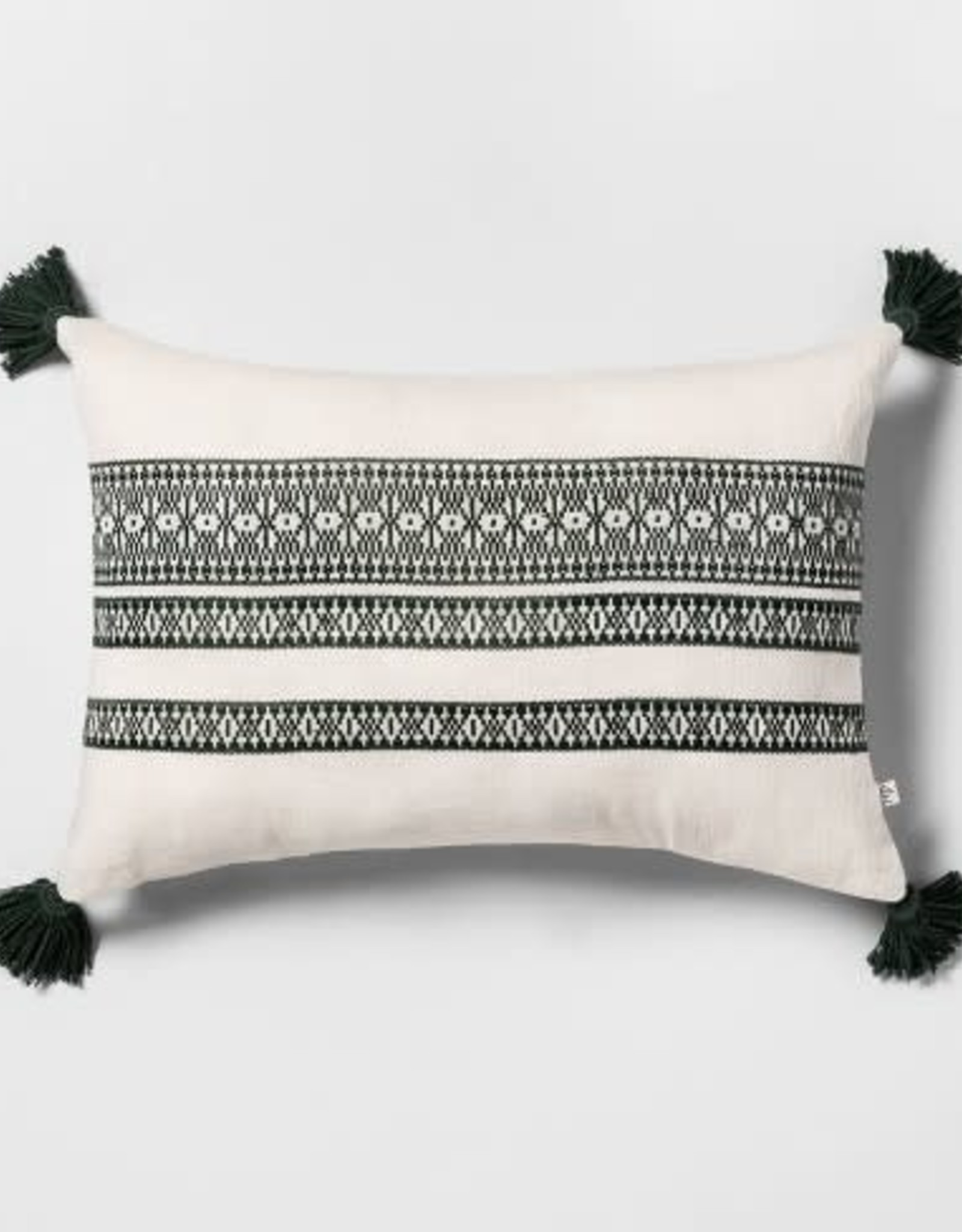 White throw pillows with green stitch & tassels