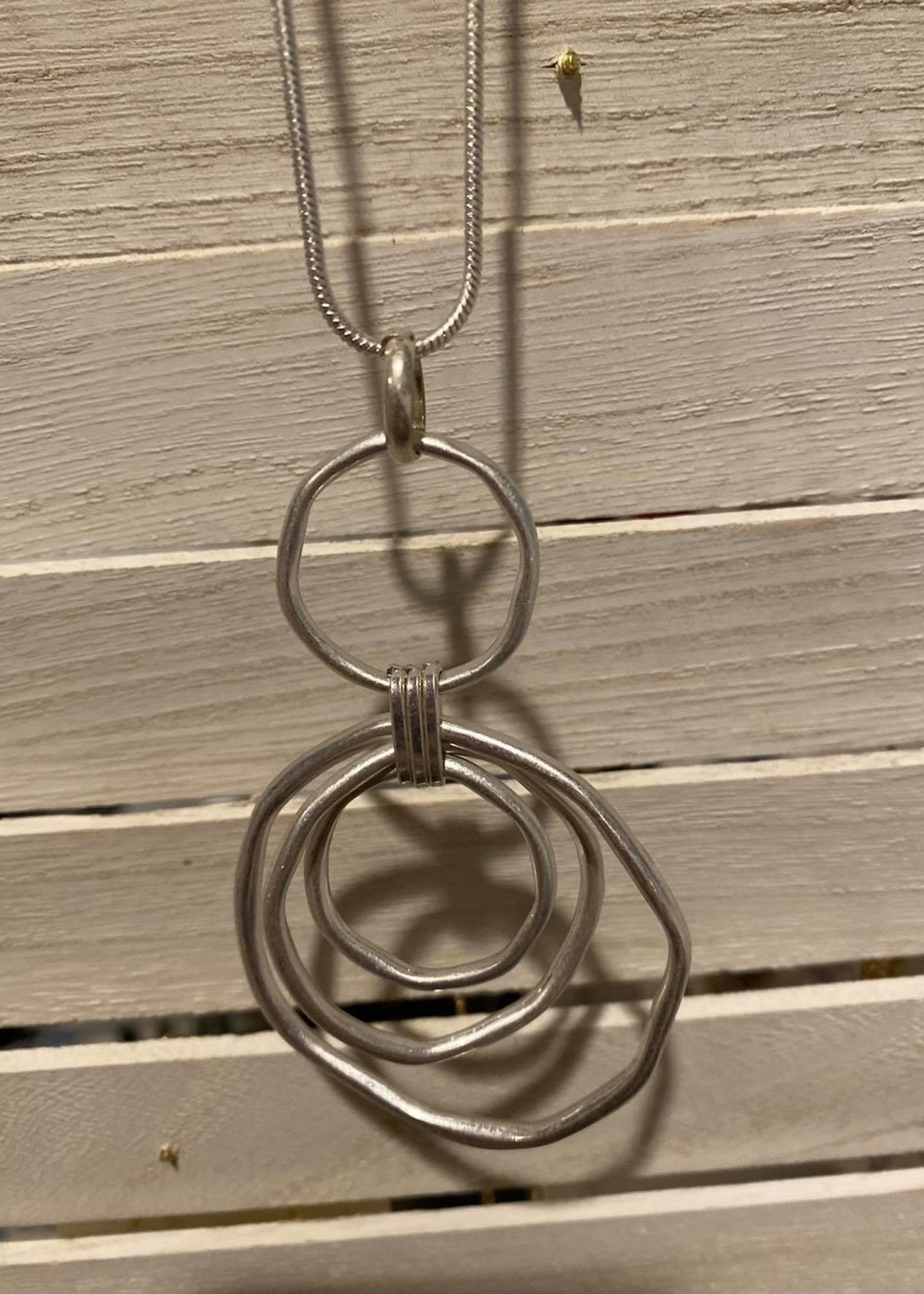 Long silver necklace with three circles