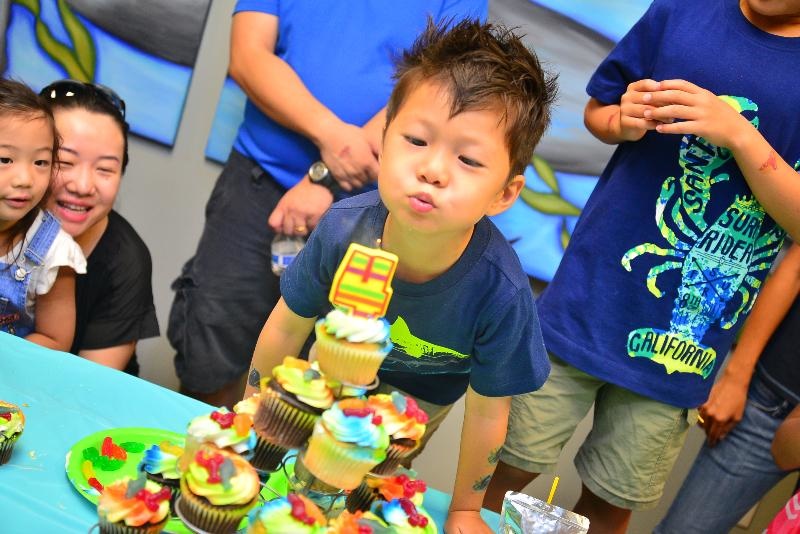 Child Blowing out Candles