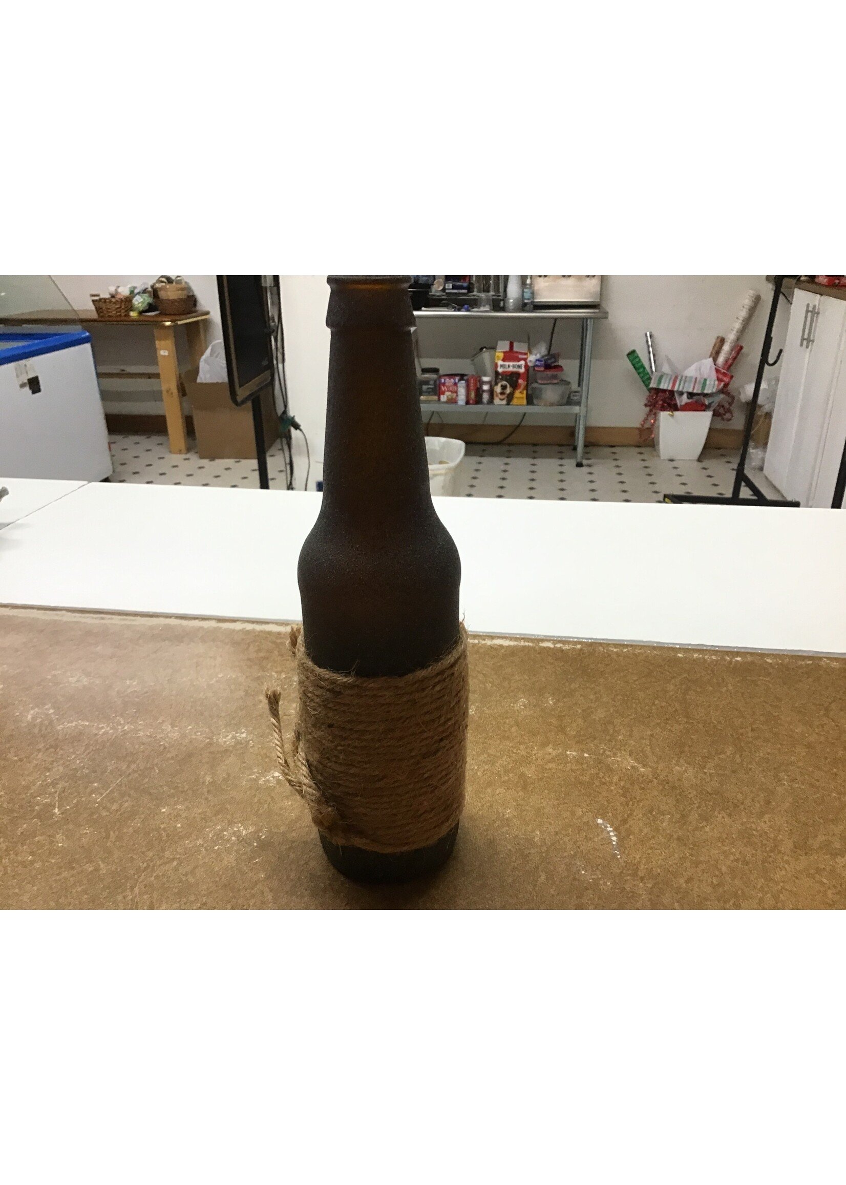 Brown frosted bottle with burlap cord wrap