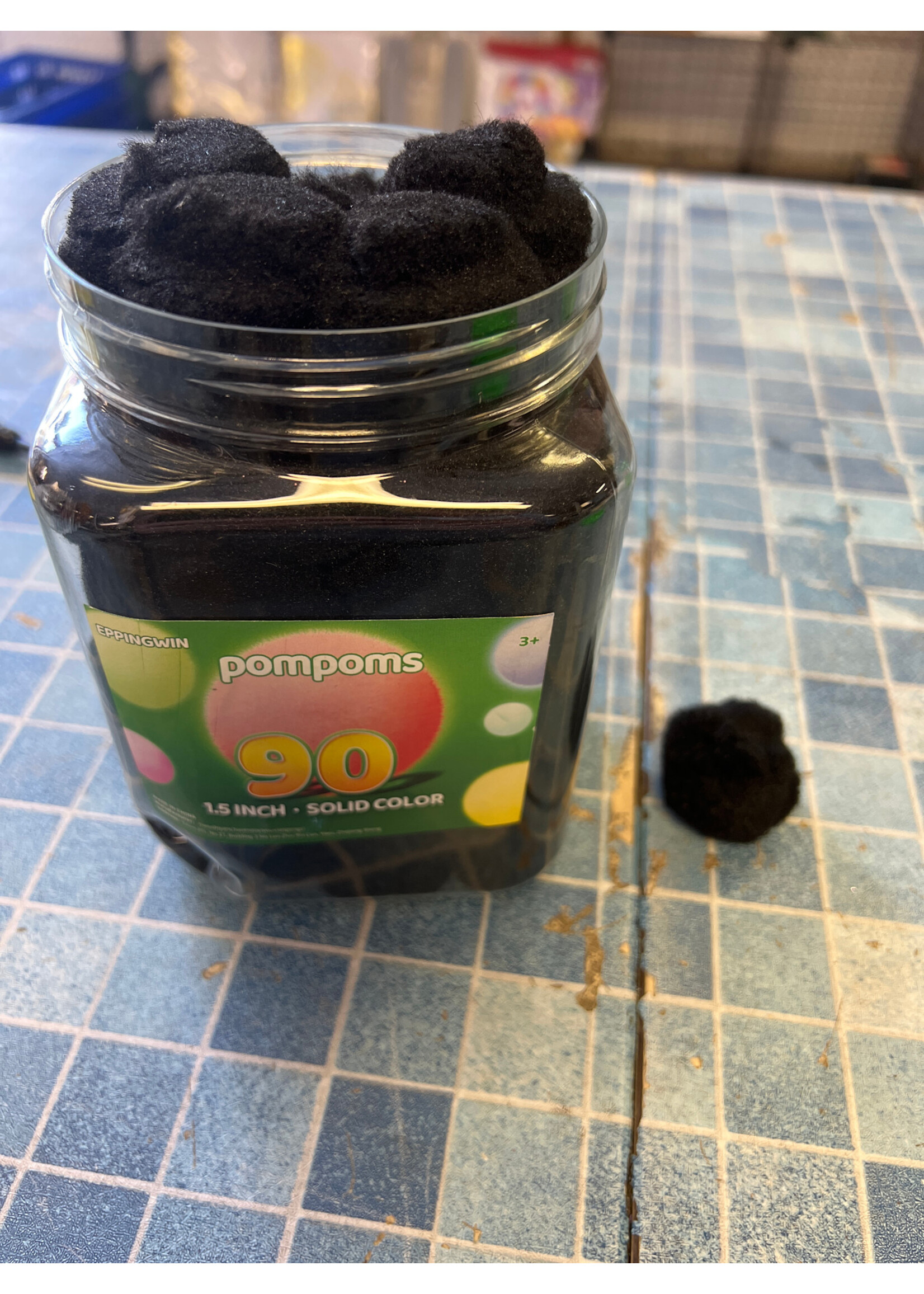 Dented container- Eppingwin 90ct solid black 1.5” pompoms