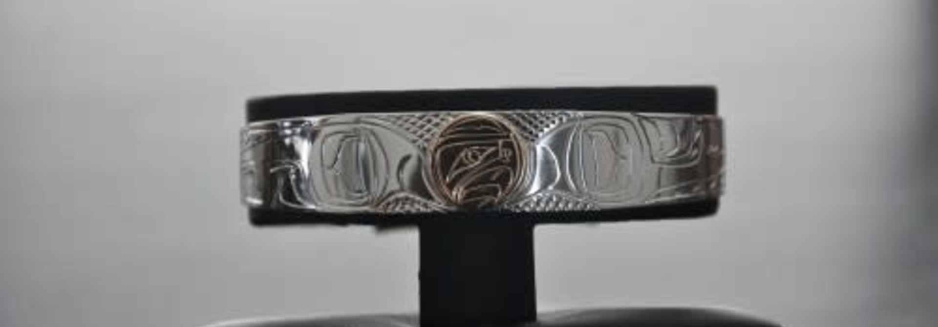 1/2" Wide hand carved silver Bracelet With a 14Kt Gold Disc In The Eagle Design. Handmade by Nancy Dawson