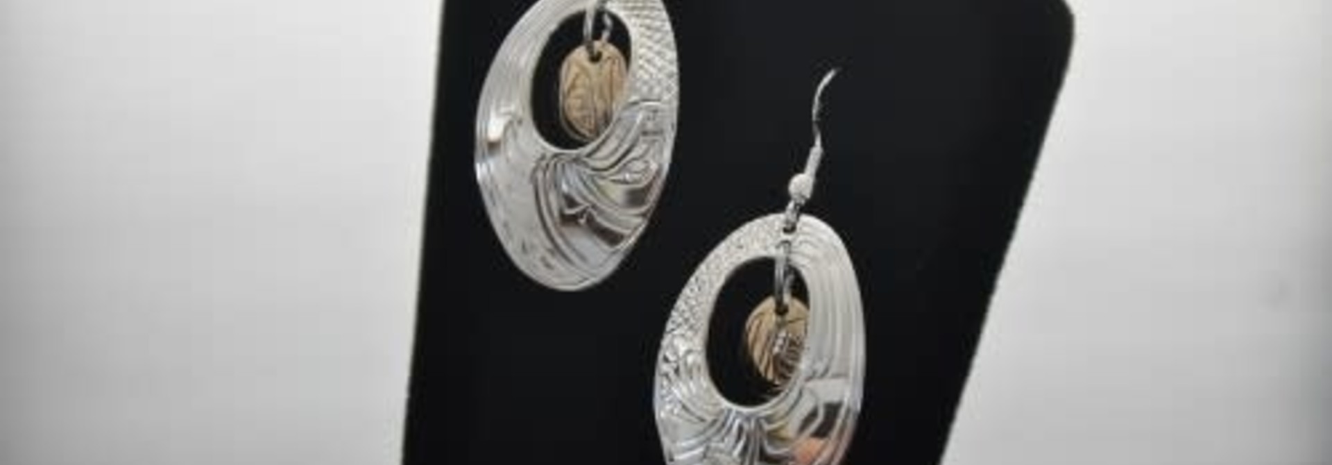 Hand Carved Silver Oval Earrings with 14k gold oval in Centre. Eagle design by Nancy Dawson