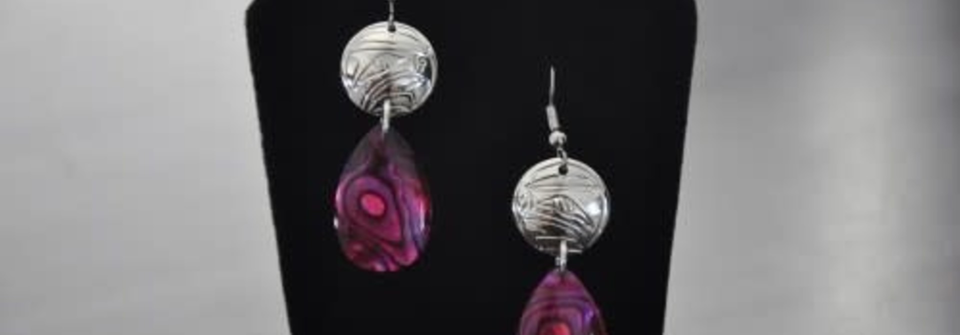 Silver circle earrings with a teardrop shaped pink paua shell