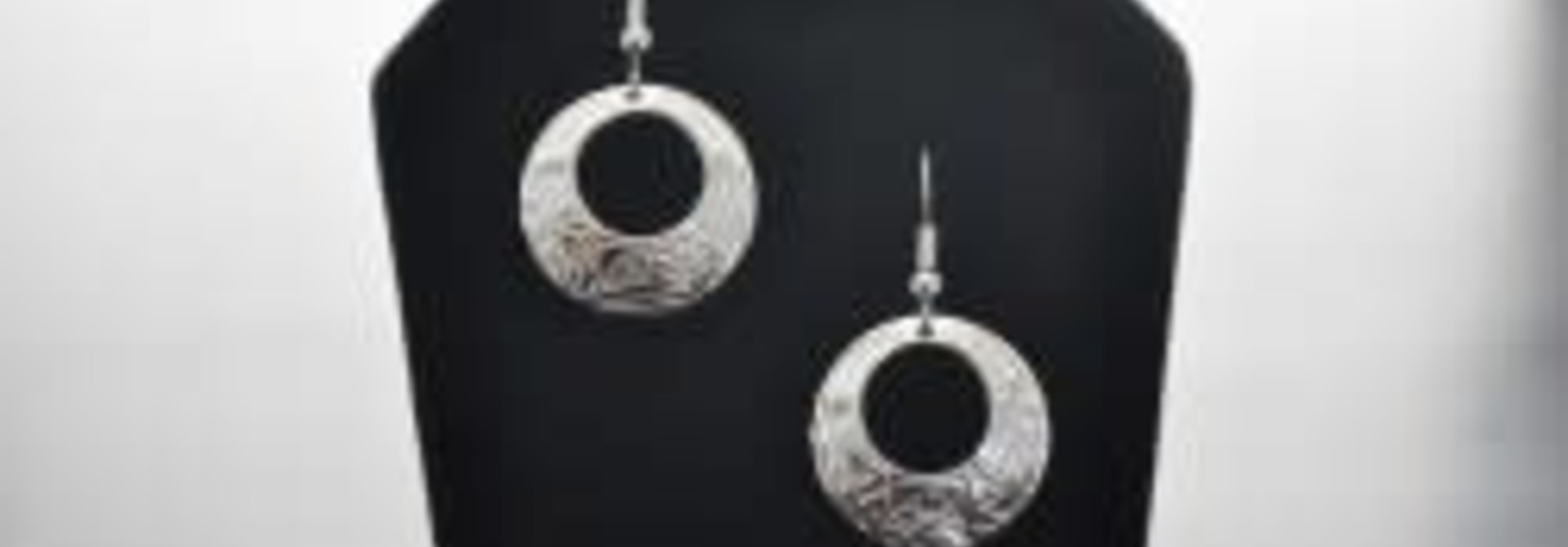 Silver circle shaped earrings eagle design by Vincent Henson
