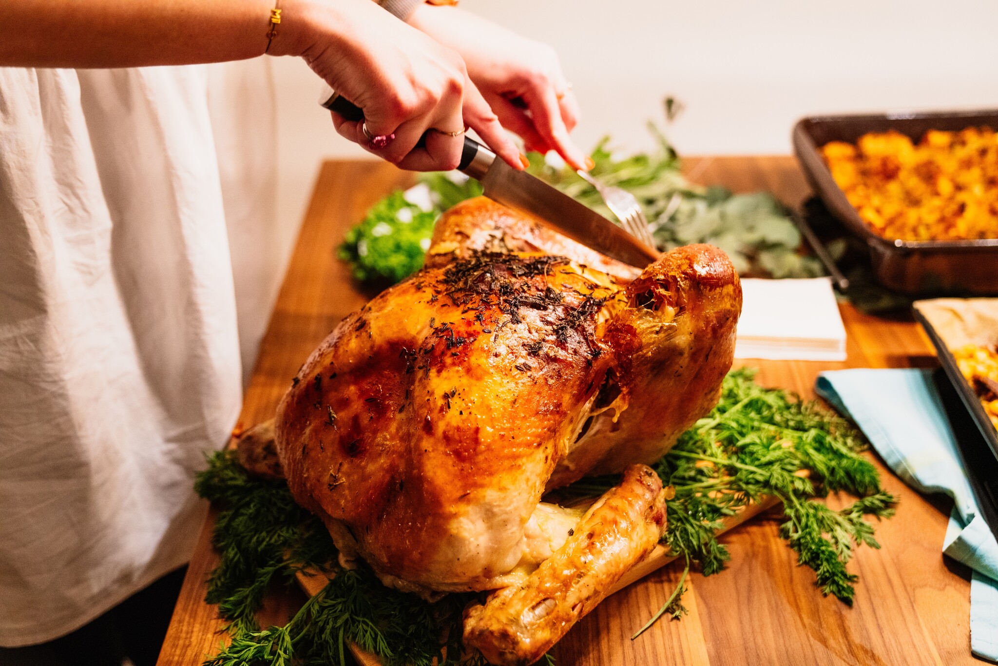 Somebody about to slice into a Thanksgiving turkey. 