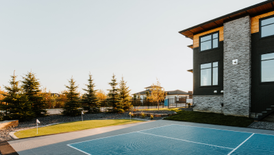 Image of a tennis court and Bella Turf putting green.