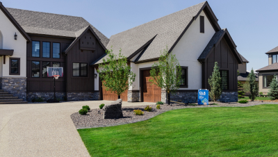 Image of a front lawn with decorative rock and a feature boulder.