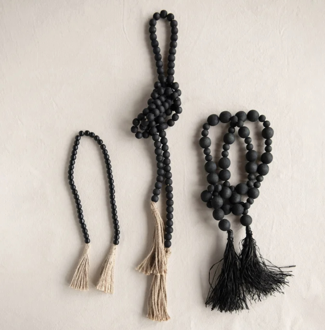 CREATIVE CO-OP Wood Bead Garland With Jute Tassels