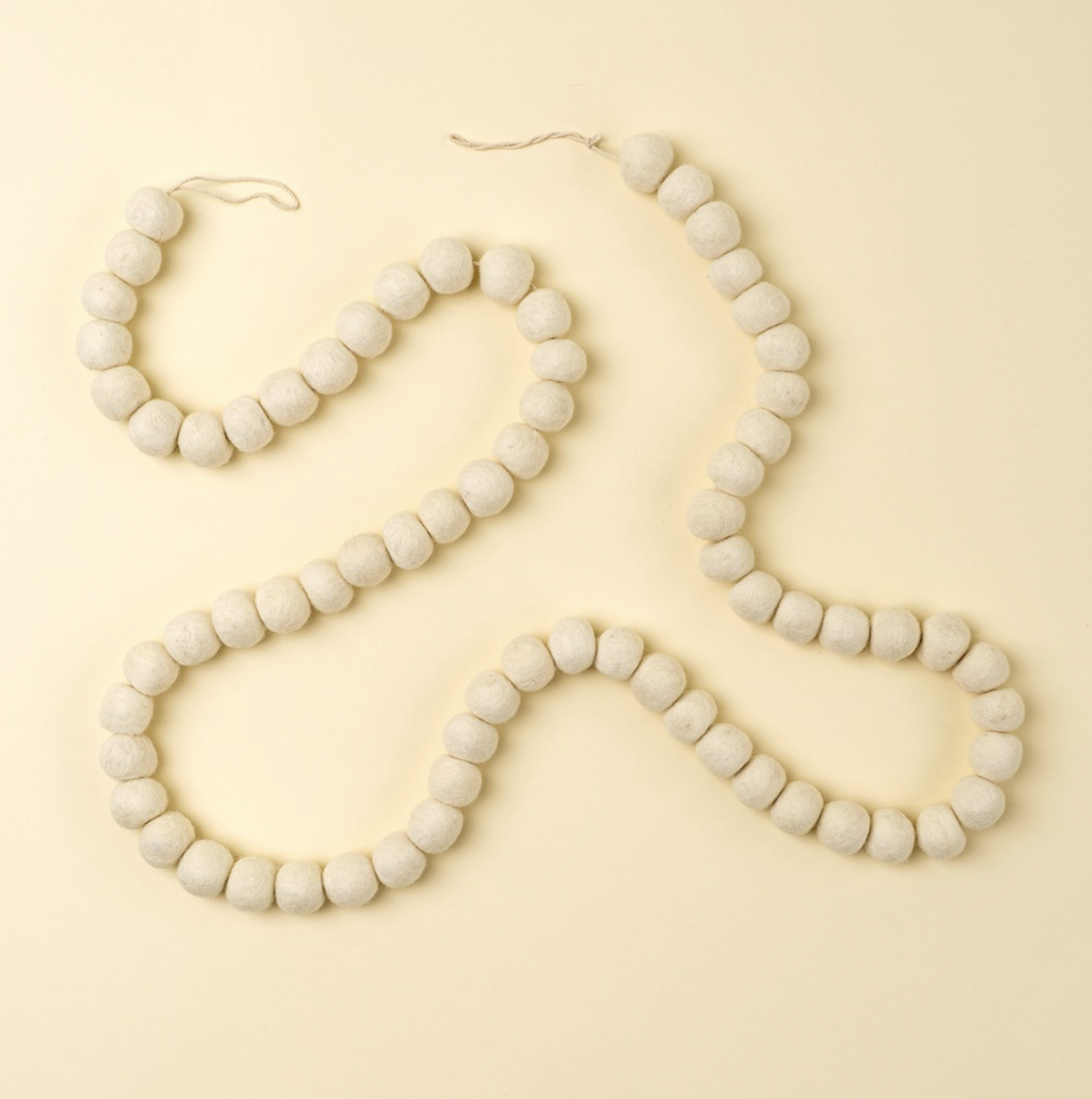 Indaba Trading Co. Cream Pom Pom Felt Garland
