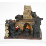 Bear family reading by fire