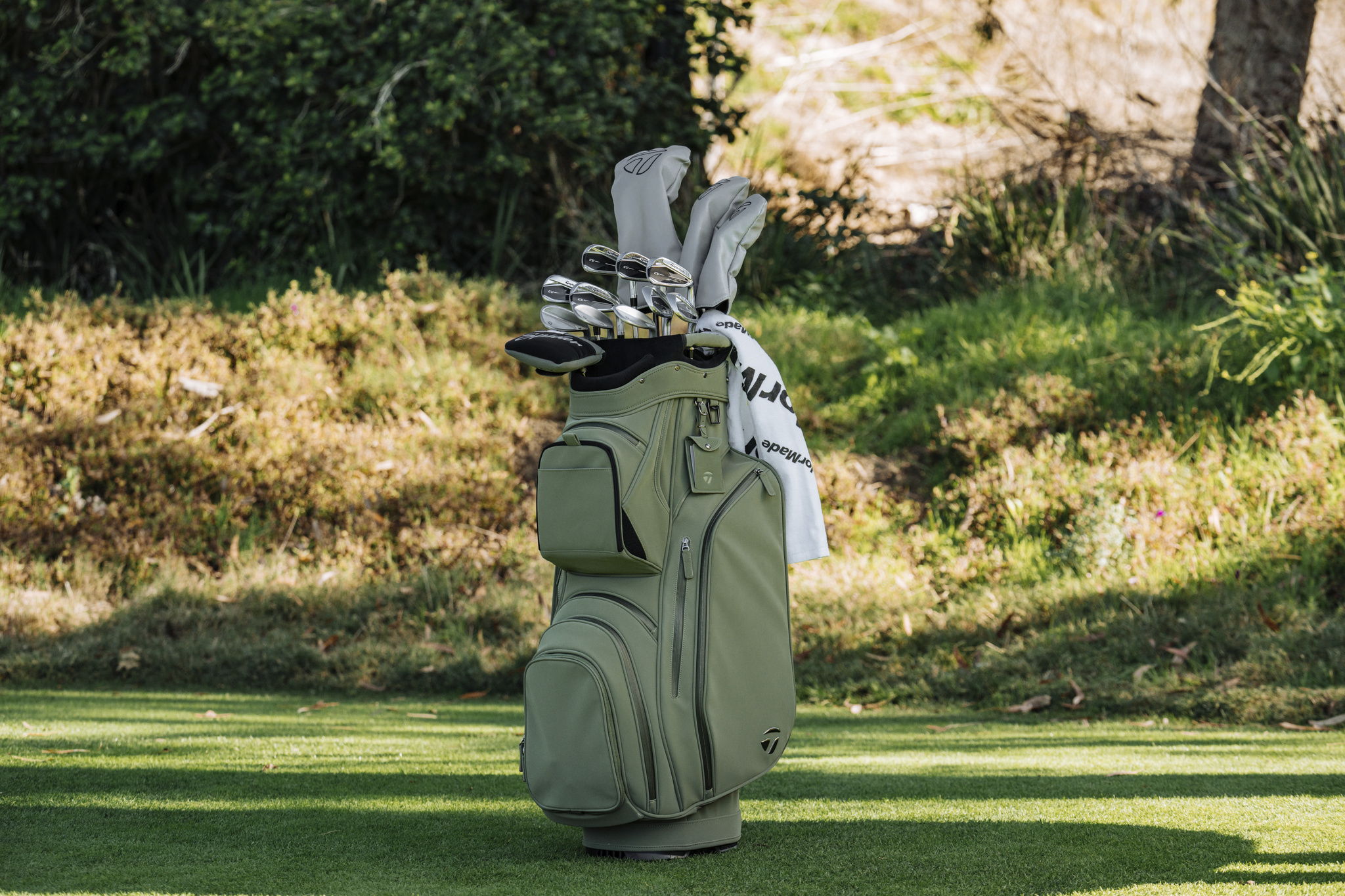 Cart bags with a sturdy design, including multiple compartments and a trolley-friendly base, offering ample storage and easy access to golf gear on the course