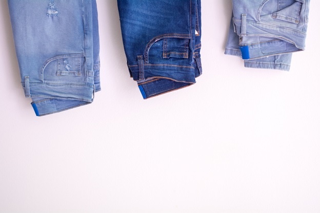 Three pairs of jeans on a white background