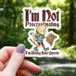Mimic Gaming Co Sticker: Cat Doing Side Quests - 3"