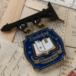 The Creeping Moon Enamel Pin - Bookshop Sign