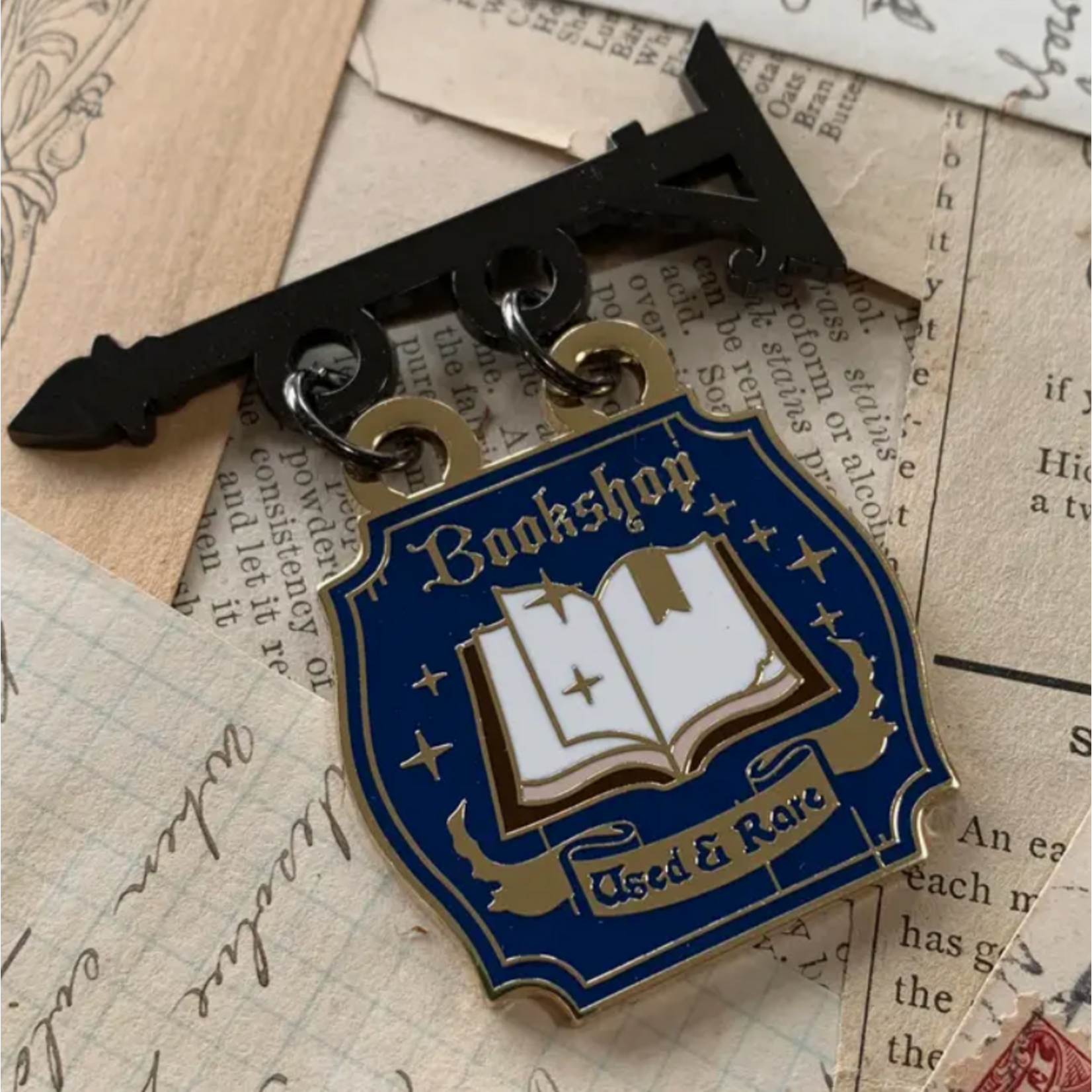 The Creeping Moon Enamel Pin - Bookshop Sign