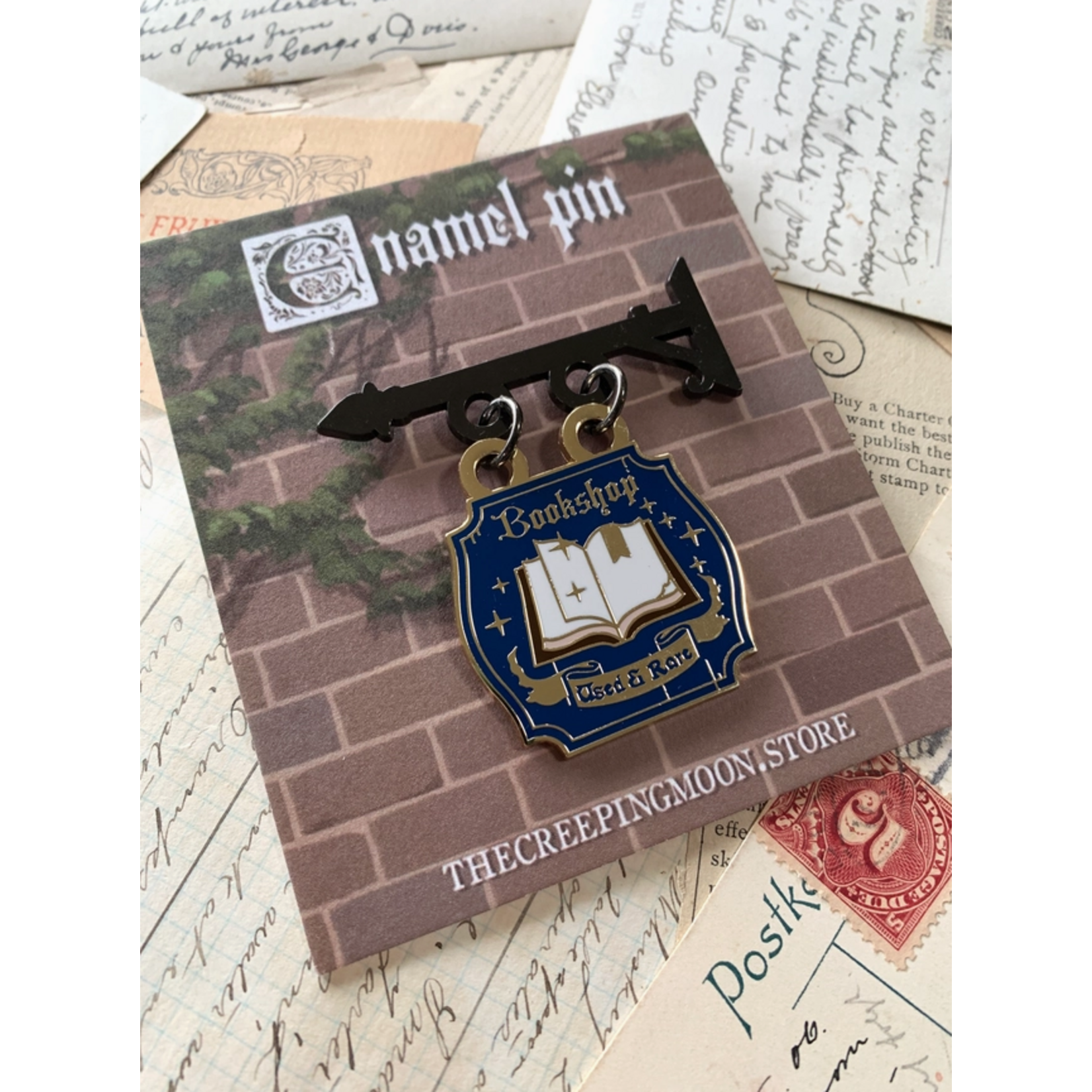 The Creeping Moon Enamel Pin - Bookshop Sign