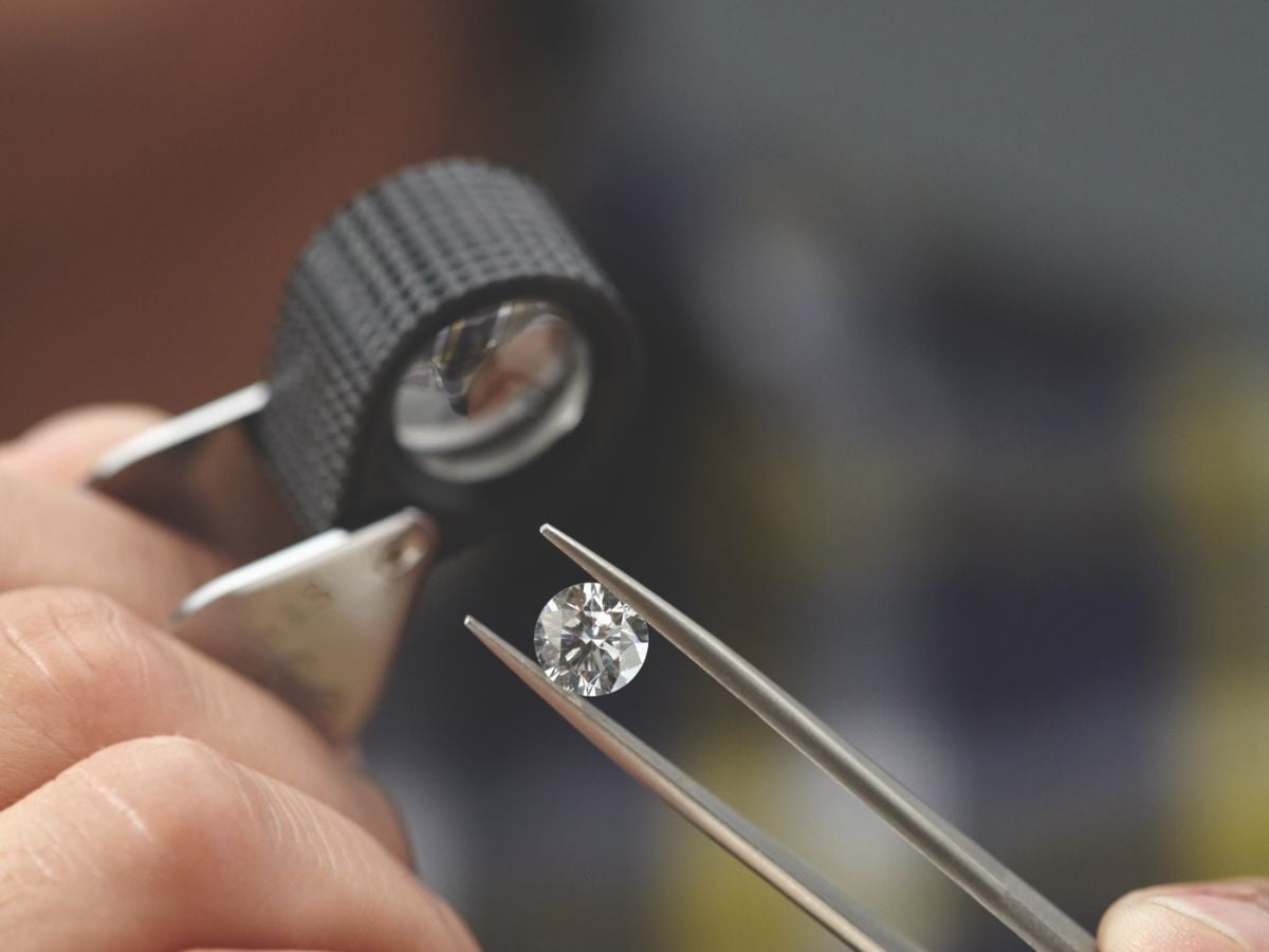 examining a diamond at Expressions Jewelers