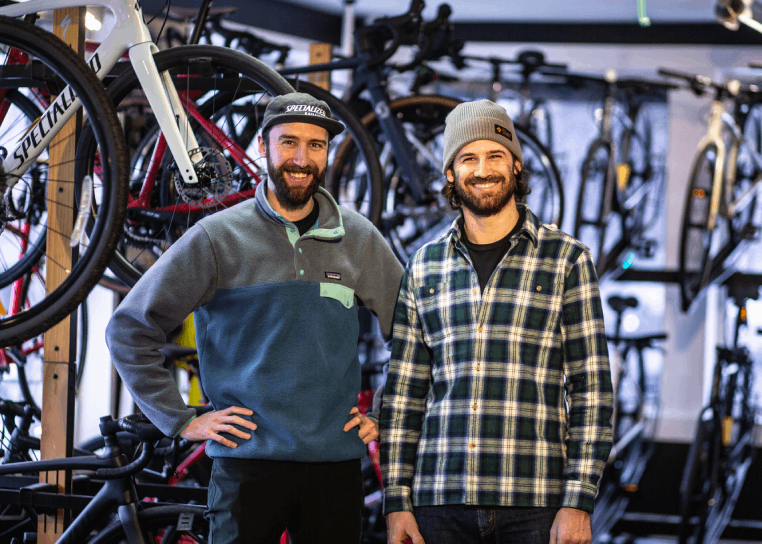 Two davélo team members standing inside the Montréal bicycle shop