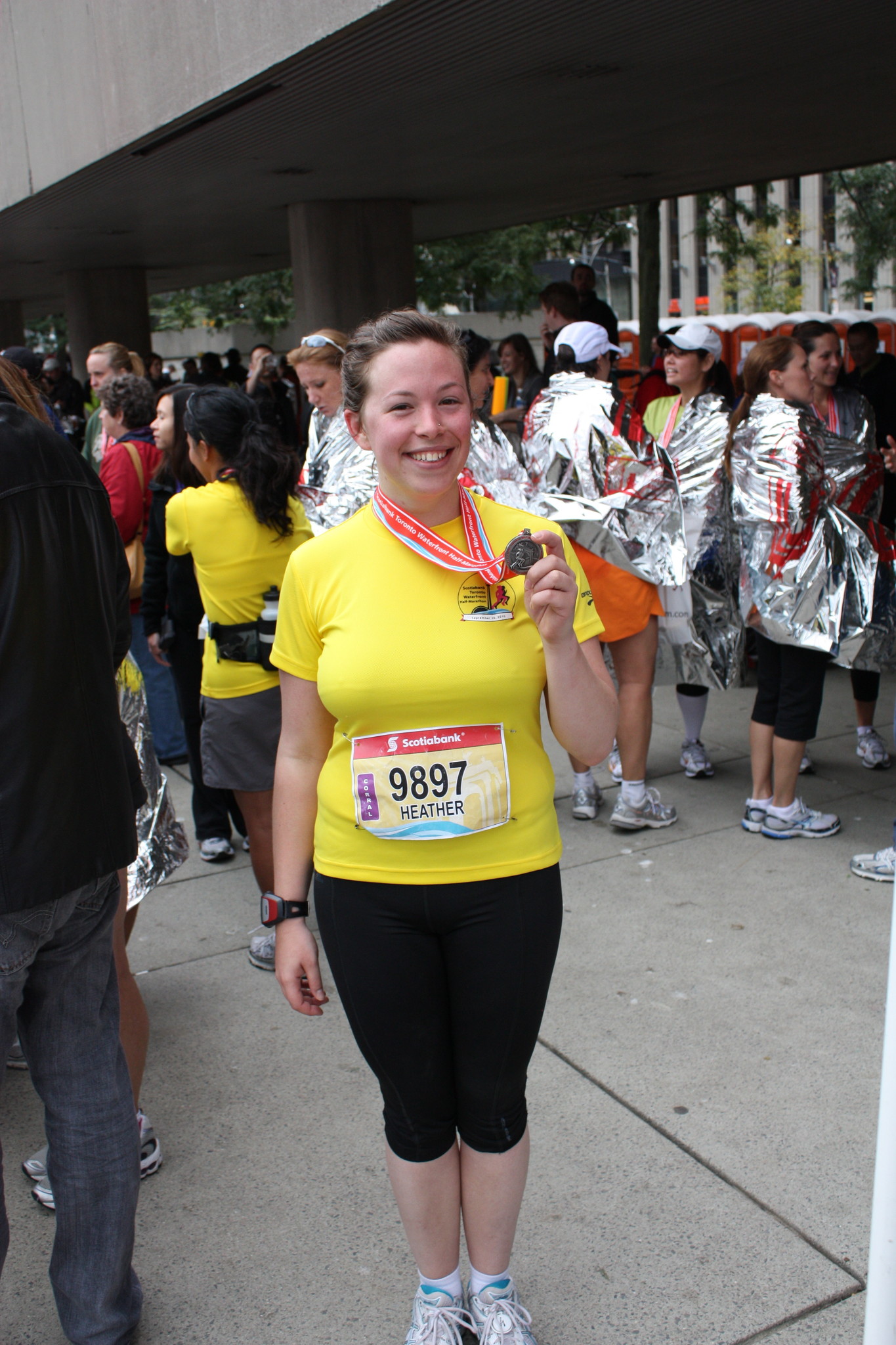 Heather finishing half marathon in almost the same location as her TOAF booth